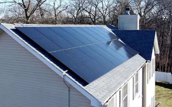 Close-up of a 13.86 kW rooftop solar panel installation by SunPol Solar on a white home in Southington, CT
