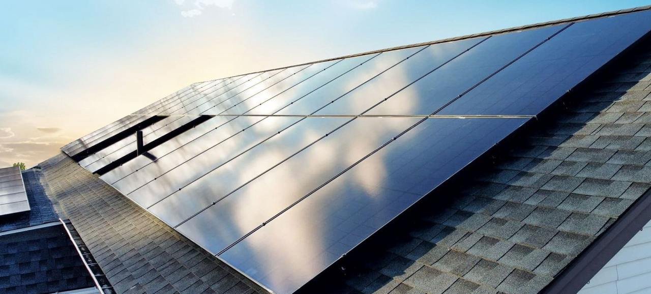 Close-up of black solar panels at sunset